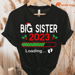 Big Sister 2023 Christmas Pregnancy Announcement Xmas Pj T-shirt hanging on a hanger