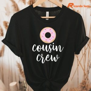 Cousin Crew Pink Donut Christmas T-Shirt hanging on a hanger