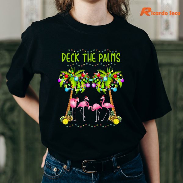 Deck the Palms Merry Flamingo Christmas T-shirt is being worn