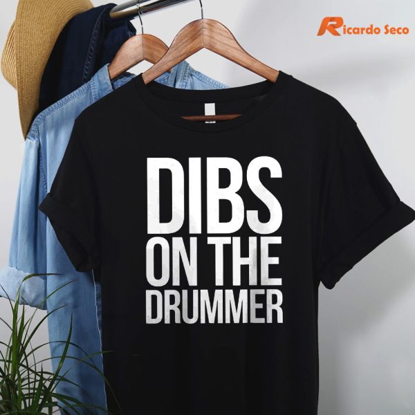 Dibs On The Drummer T-shirt hanging on a hanger
