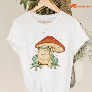 Frog Mushroom Umbrella T-shirt hanging on a hanger