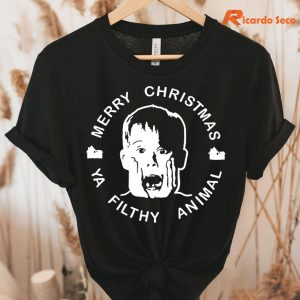 Home Alone Noel Christmas T-Shirt hanging on a hanger