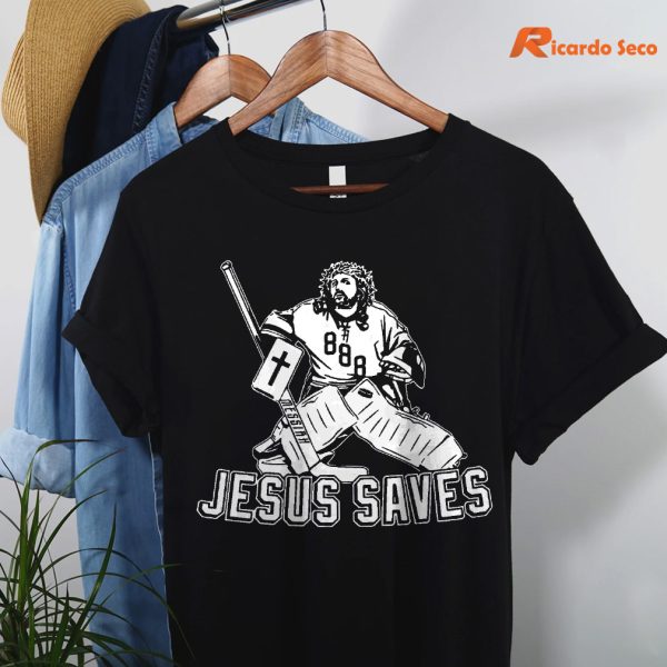 Jesus Saves Hockey T-shirt hanging on a hanger