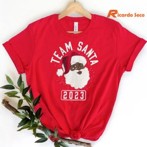 Matching Family Team Santa Chistmas T-shirt hanging on a hanger