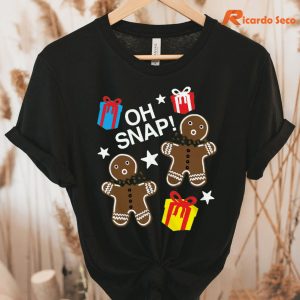 Oh Snap! Gingerbread Man & Presents Specialty Soft Hand T-shirt hanging on a hanger