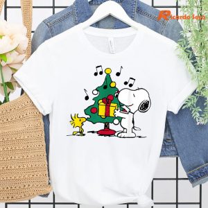 Peanust Snoopy and Woodstock Holiday Christmas Tree T-Shirt hanging on a hanger