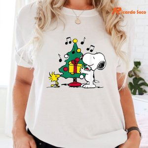 Peanust Snoopy and Woodstock Holiday Christmas Tree T-Shirt is worn on the body