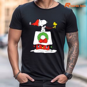 Peanuts Holiday Snoopy's Doghouse Sleigh T-Shirt is worn on the body