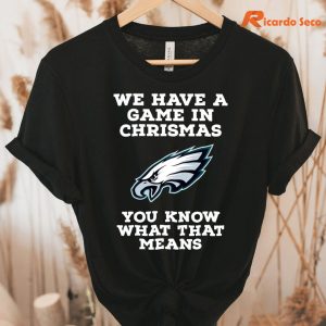 Philadelphia Eagles Christmas Game T-Shirt hung on a hanger