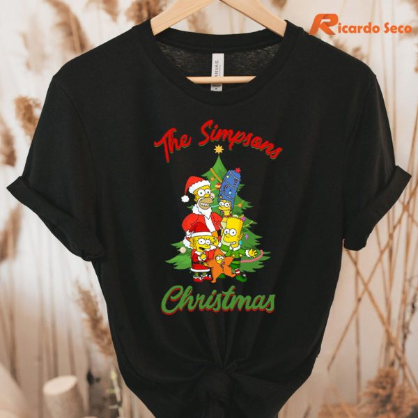 The Simpsons Family Christmas Tree Holiday T shirt hung on a hanger