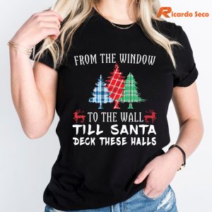 From The Window To The Wall Till Santa Decks These Halls T-Shirt hung on a hanger
