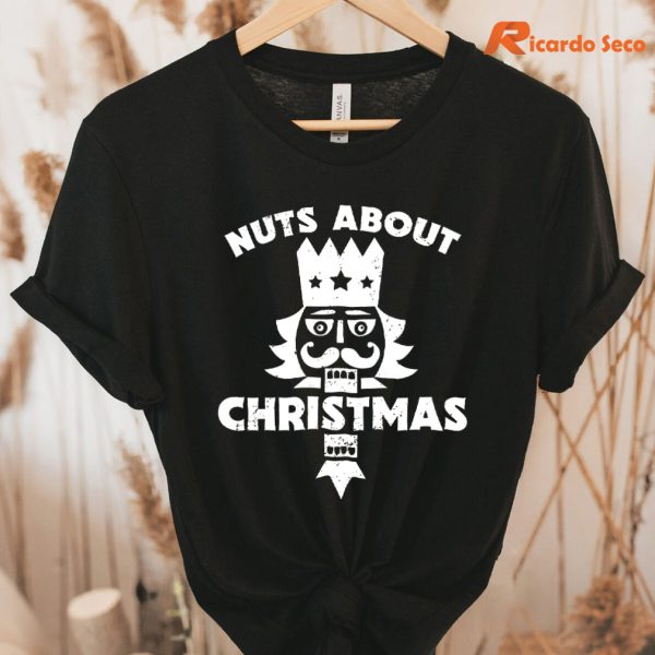Nuts About Christmas - Funny Christmas Nutcracker T-Shirt hung on a hanger