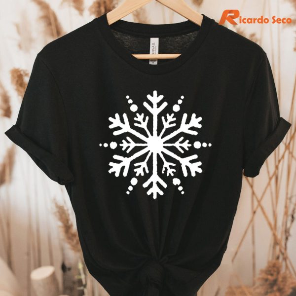 Snowflake Christmas T-shirt hung on a hanger